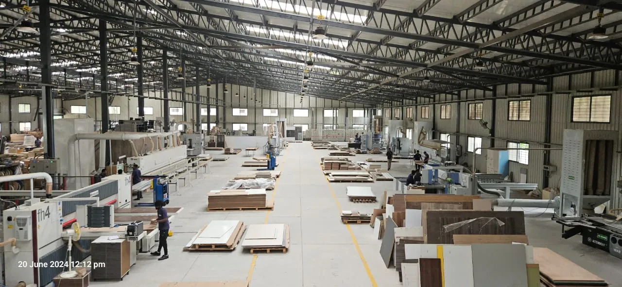Production floor at Portals with edge-banding lines and stacked boards
